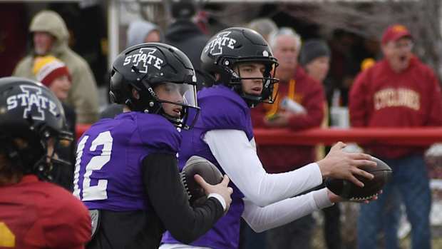 Iowa State quarterbacks Hunter Dekkers (left) and Ashton Cook throw the ball during open spring practice at Gilbert High School Friday, April 15, 2022, in Ames, Iowa.